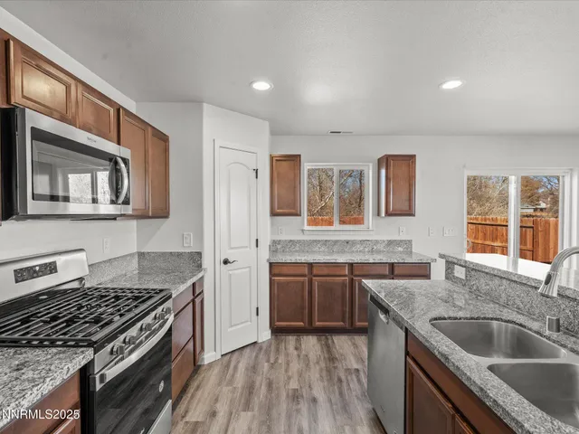 a kitchen with stainless steel appliances granite countertop a stove and a sink