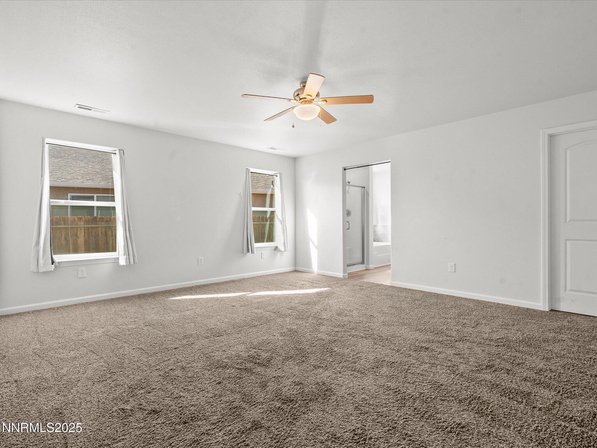 2041 Verona Drive Fallon, NV 89406 - Photo 17 of 45 a view of an empty room with window and a kitchen view