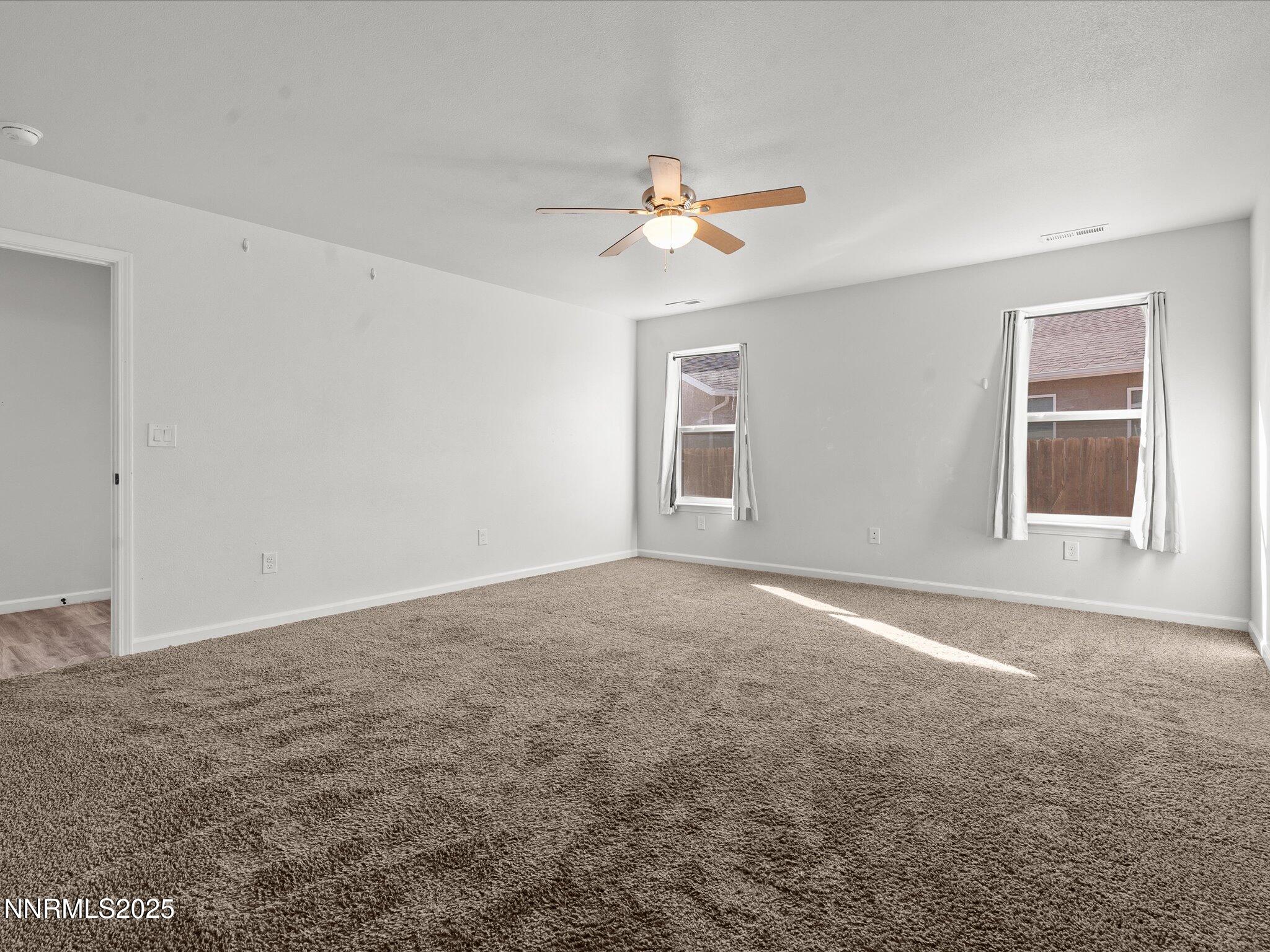 2041 Verona Drive Fallon, NV 89406 - Photo 18 of 45 an empty room with windows and fan