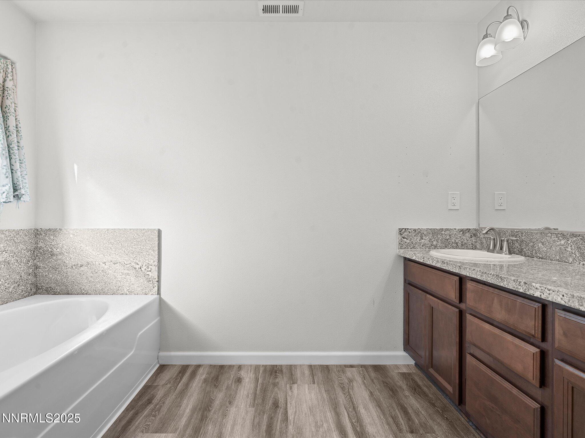 2041 Verona Drive Fallon, NV 89406 - Photo 22 of 45 a bathroom with a granite countertop sink and a bathtub
