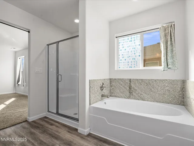 a bathroom with a bathtub and a shower