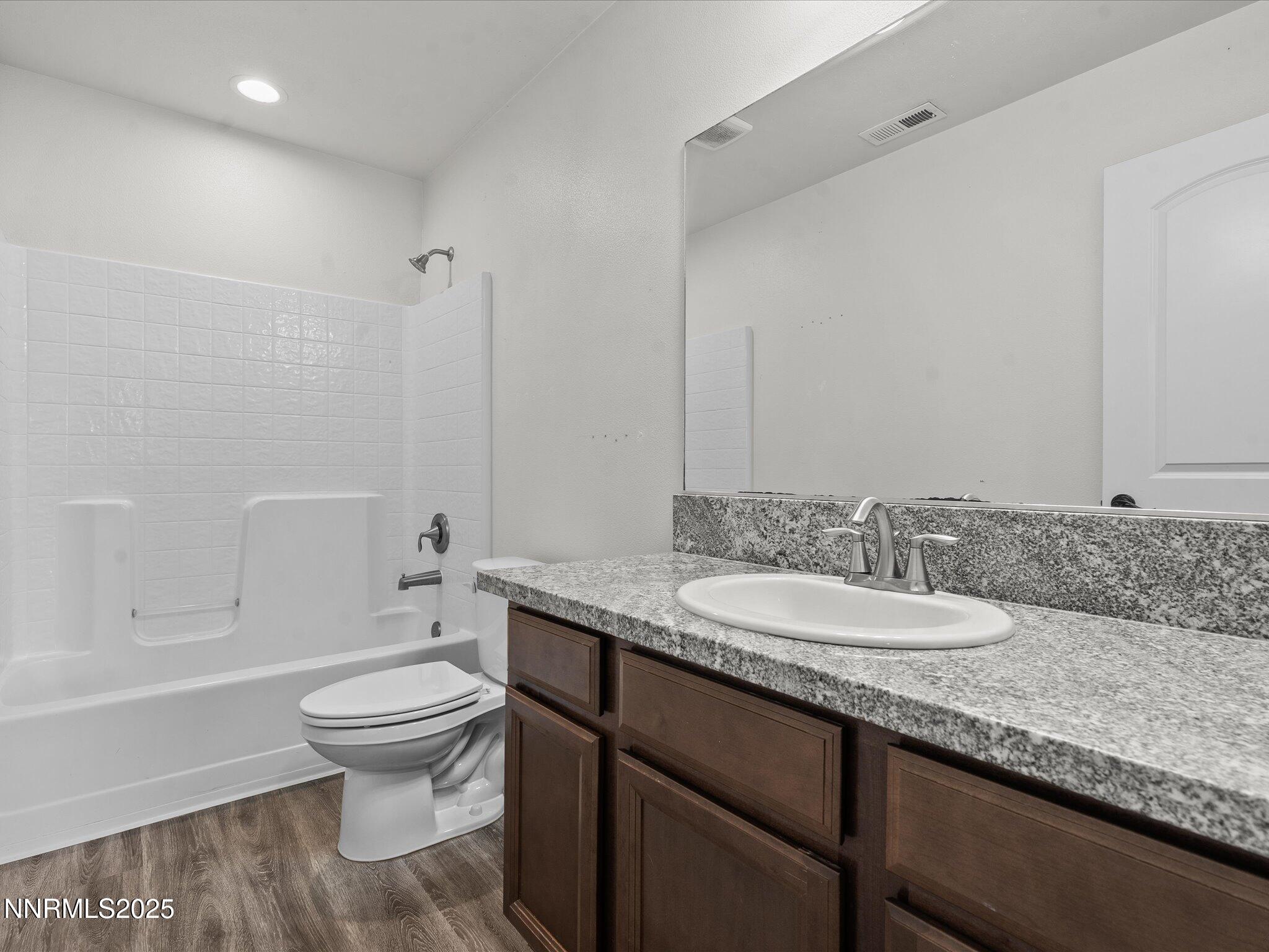 2041 Verona Drive Fallon, NV 89406 - Photo 27 of 45 a bathroom with a granite countertop toilet sink and mirror