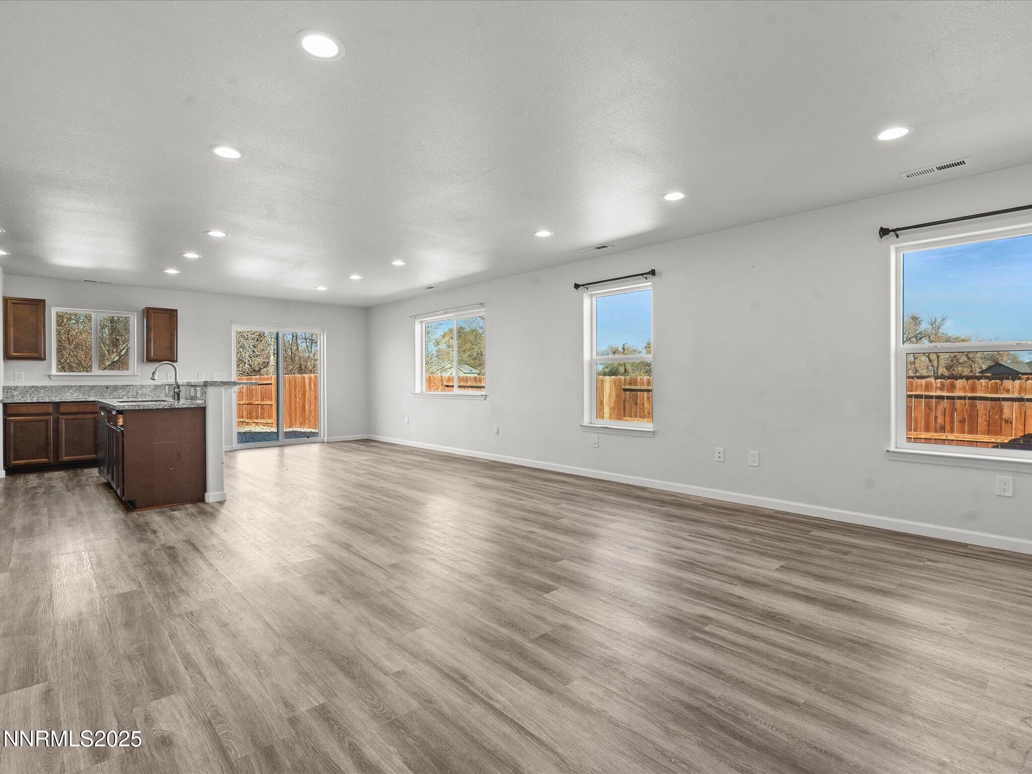 2041 Verona Drive Fallon, NV 89406 - Photo 5 of 45 an empty room with wooden floor and windows