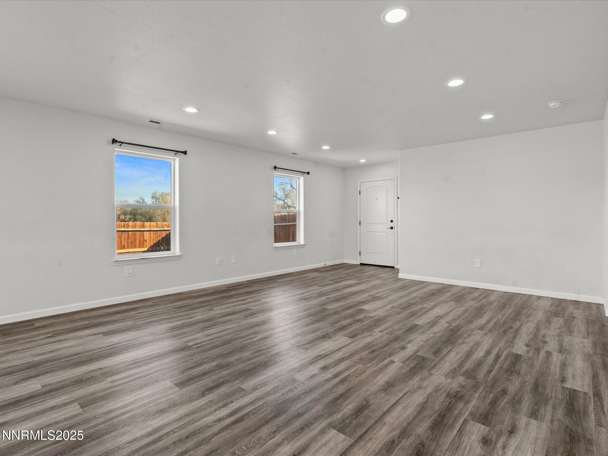 2041 Verona Drive Fallon, NV 89406 - Photo 6 of 45 an empty room with wooden floor and windows