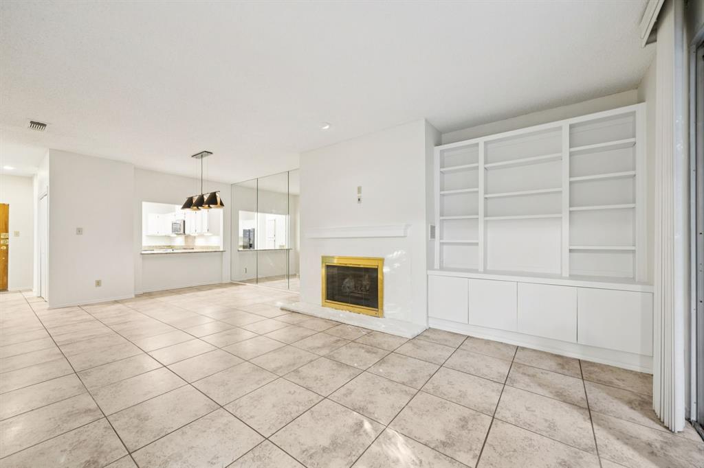 5310 Keller Springs Road, Unit 612 Dallas, TX 75248 - Photo 13 of 33 Serving bar with space for barstools from the kitchen to dining area.