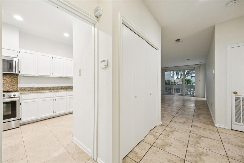 5310 Keller Springs Road, Unit 612 Dallas, TX 75248 - Photo 16 of 33 Corridor with tile and washer and dryer closet.