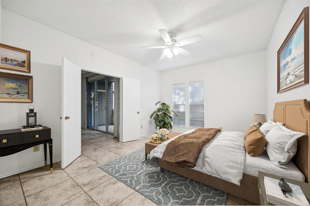 5310 Keller Springs Road, Unit 612 Dallas, TX 75248 - Photo 2 of 33 Primary bedroom at the back of the unit virtually staged.
