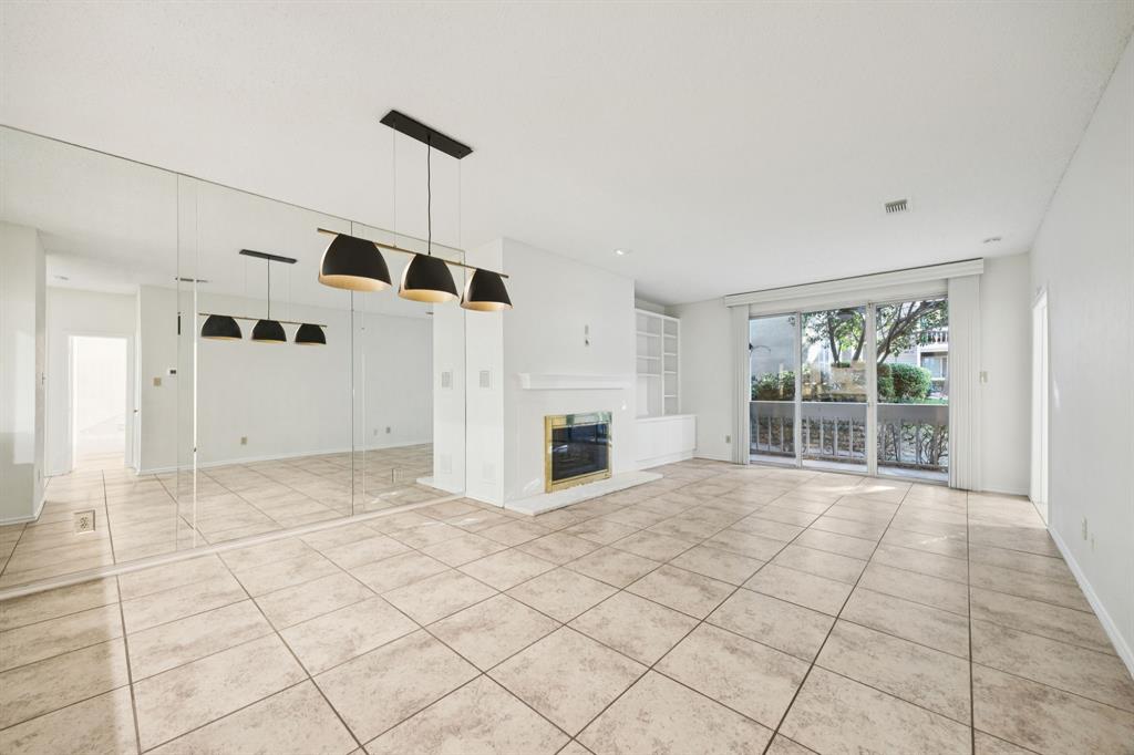 5310 Keller Springs Road, Unit 612 Dallas, TX 75248 - Photo 5 of 33 Beautiful light fixture and beveled mirror in the dining area.