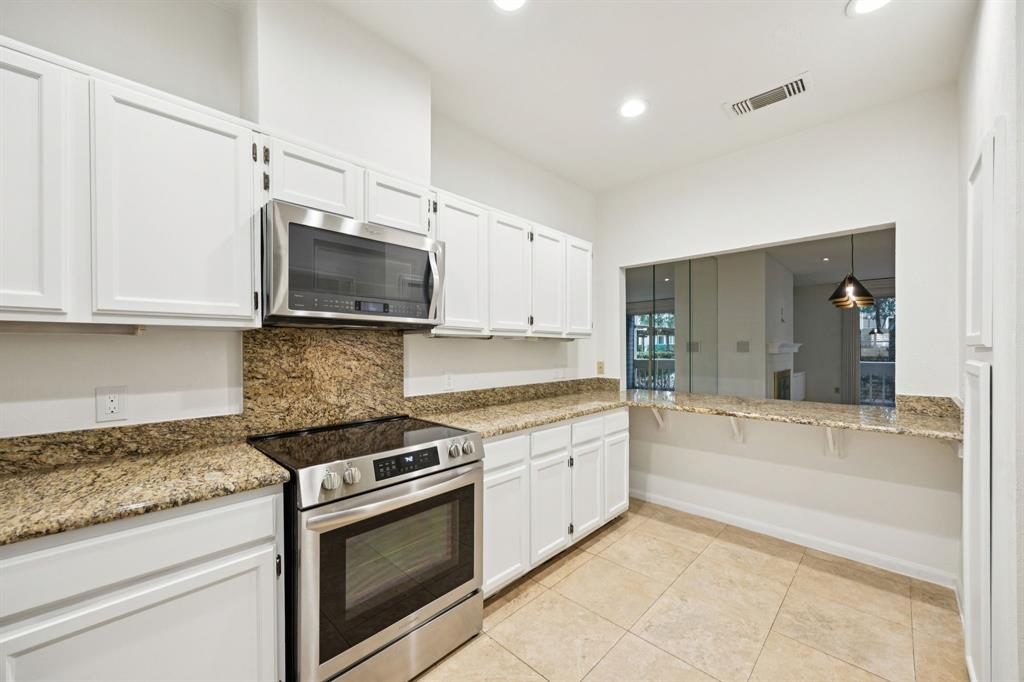 5310 Keller Springs Road, Unit 612 Dallas, TX 75248 - Photo 6 of 33 Serving bar opens to the dining area for entertaining.