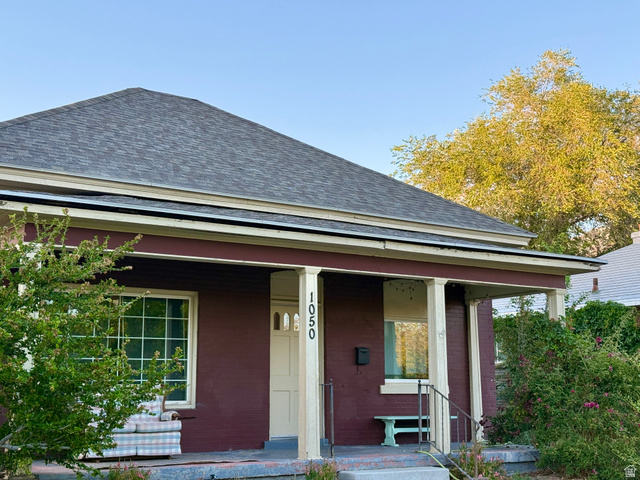 1050 West 100 North Provo, UT 84601 - Photo 2 of 16 Entry porch featuring prominent columns, a brick facade, and a shingled roof
