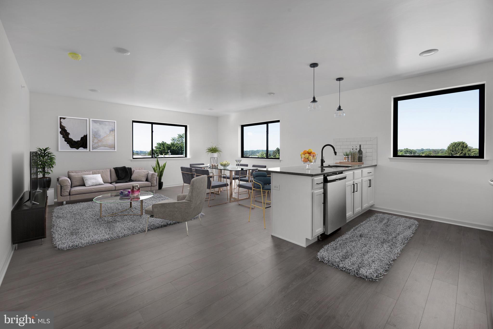 6618 Ridge Avenue, Unit 302 Philadelphia, PA 19128 - Photo 2 of 7 a living room with furniture and view of kitchen