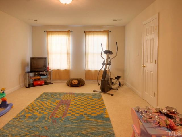 2117 Roland Glen Road Cary, NC 27519 - Photo 21 of 25 Bedroom number three could be a perfect bedroom, game room or media room. It too has a large walk in closet. Bedroom