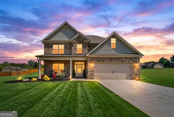 a front view of a house with a yard