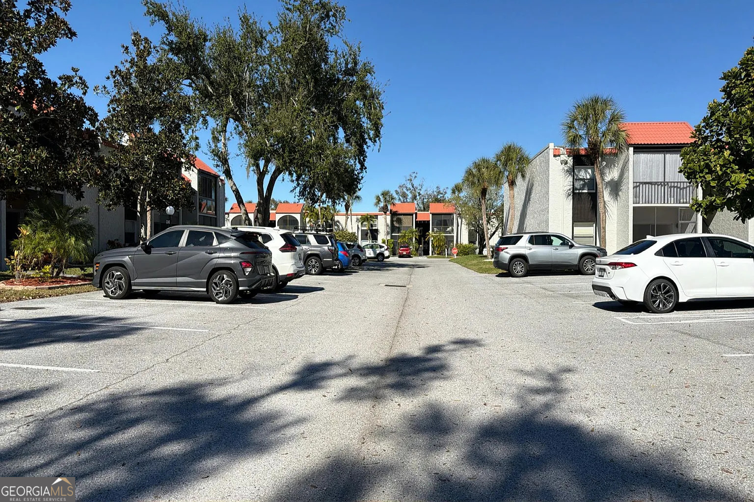3241 South Beneva Road, Unit 103 Sarasota, FL 34232 - Photo 5 of 5 a view of road with card parked on side and retail shops