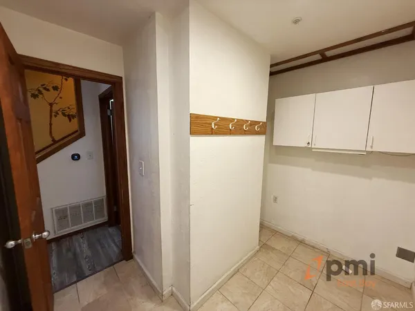 a living room with large window and wooden floor