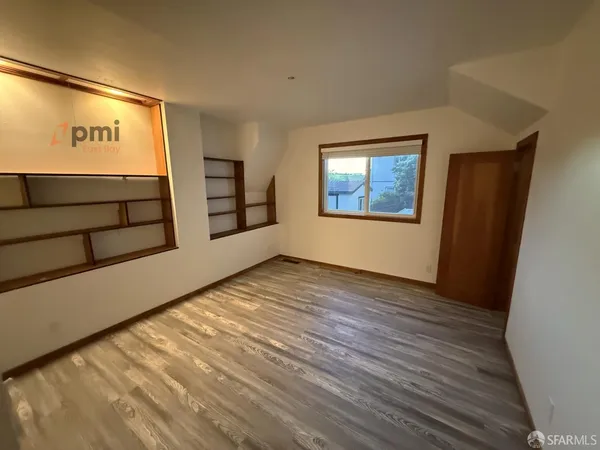 a view of entryway and hall with wooden floor
