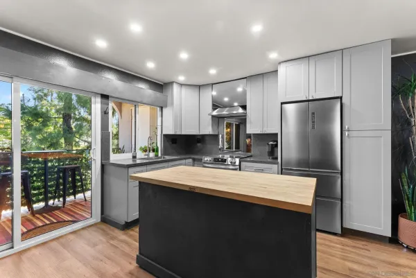 a kitchen with kitchen island a sink appliances and cabinets