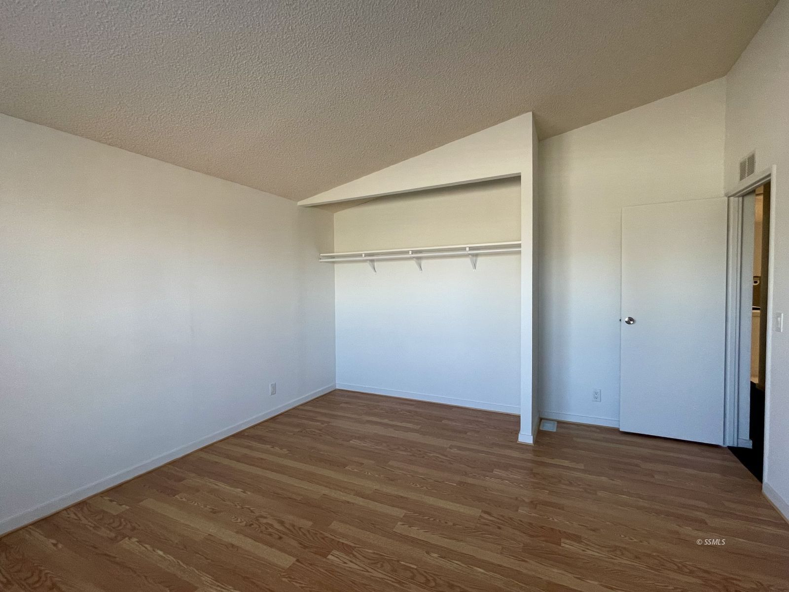 1449 Dunes Street Ridgecrest, CA 93555 - Photo 23 of 50 an empty room with wooden floor and closet