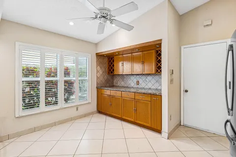 a bathroom with a granite countertop sink a mirror and a bathtub