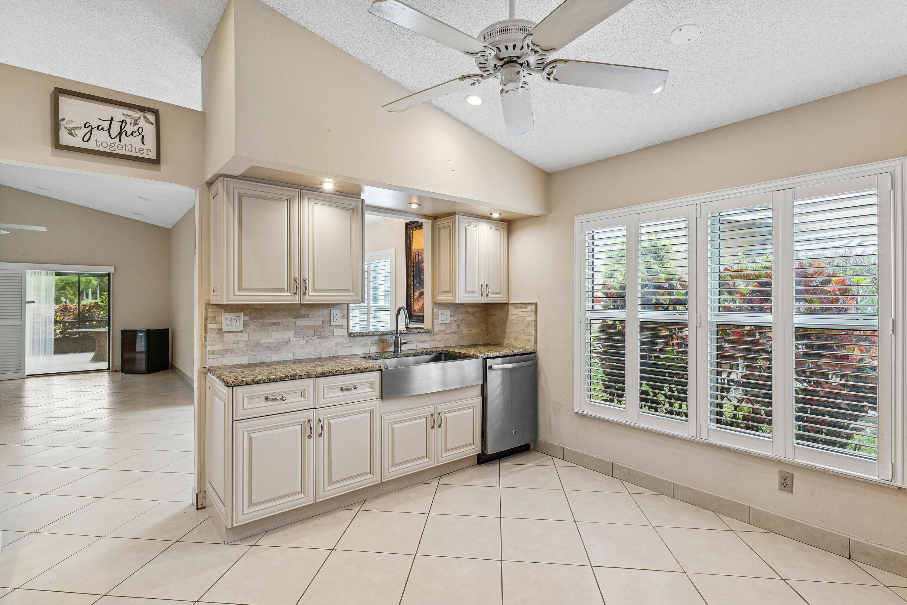 6249 Beaconwood Road Lake Worth, FL 33467 - Photo 14 of 46 a large kitchen with a large window appliances and cabinets