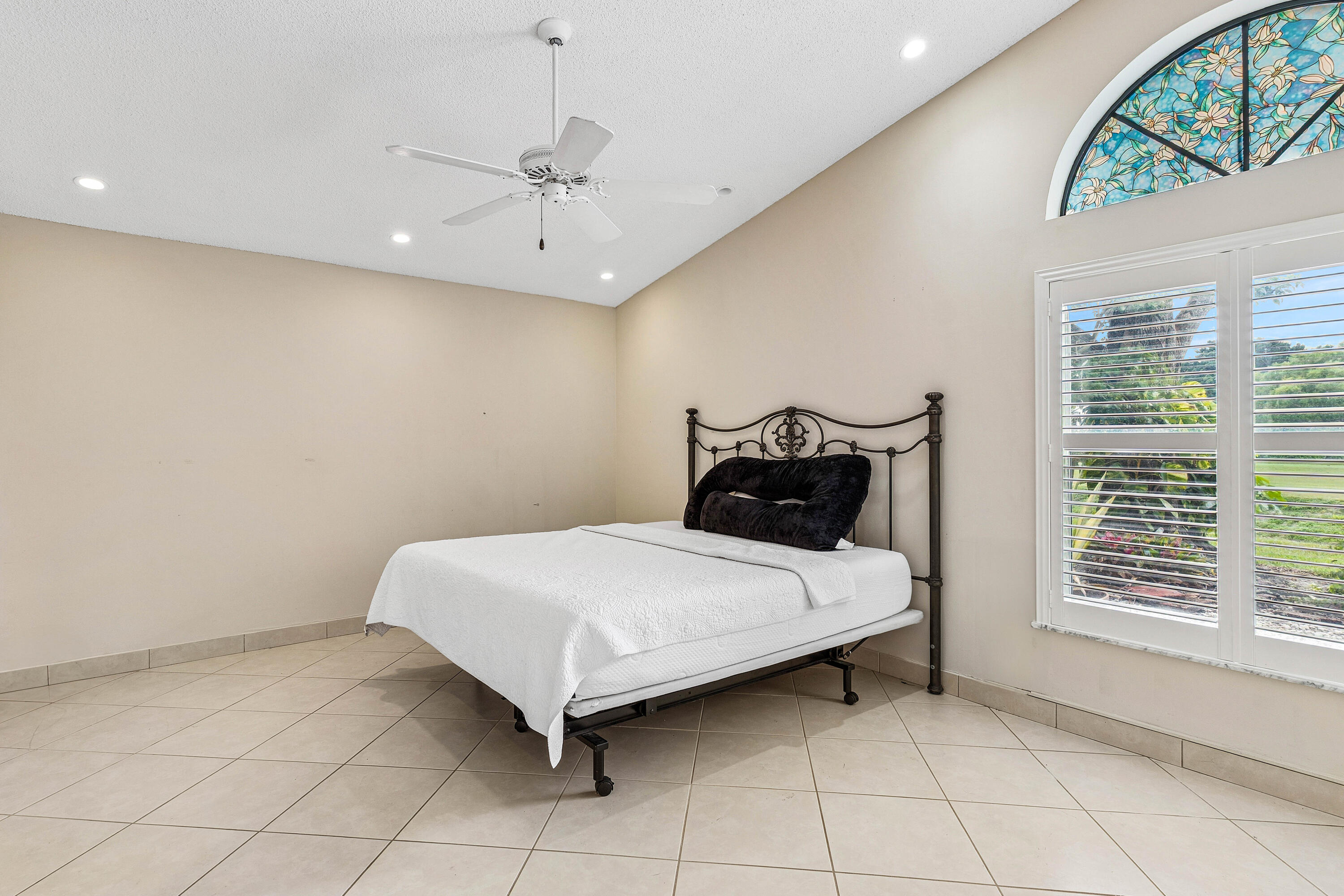 6249 Beaconwood Road Lake Worth, FL 33467 - Photo 18 of 46 a bed sitting in a room next to a window