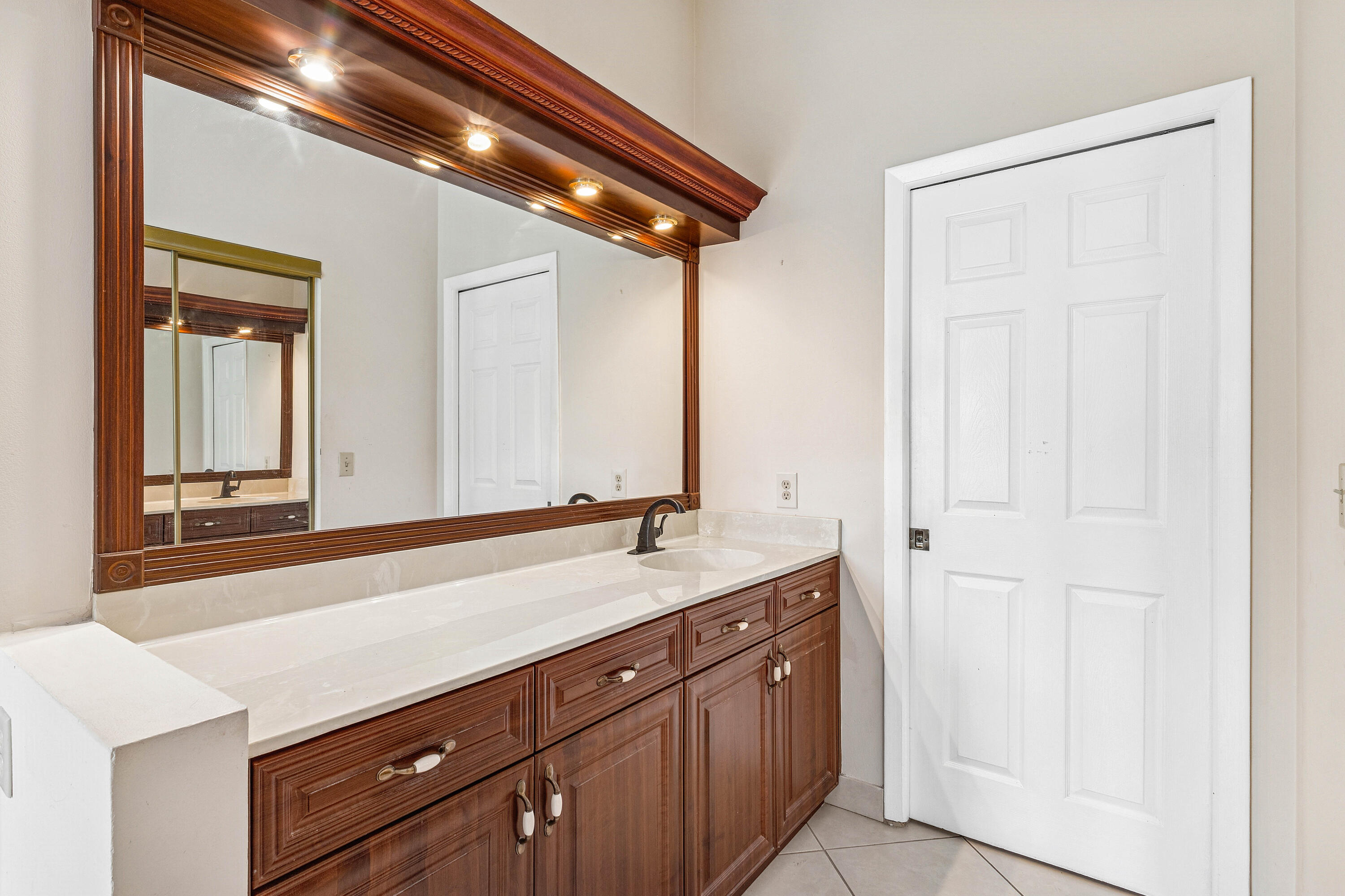 6249 Beaconwood Road Lake Worth, FL 33467 - Photo 22 of 46 a spacious bathroom with a sink and a mirror