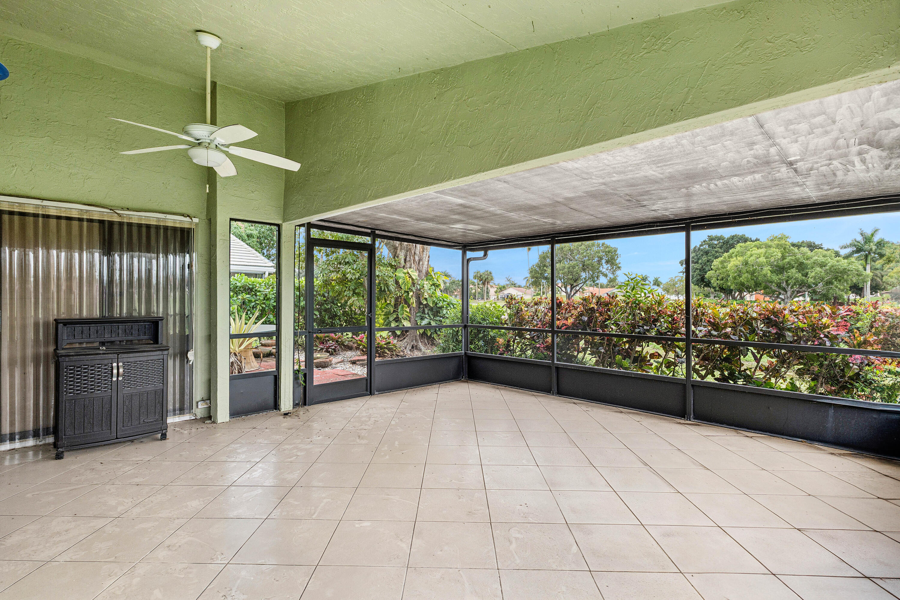 6249 Beaconwood Road Lake Worth, FL 33467 - Photo 27 of 46 a view of a room with a large window and chandelier