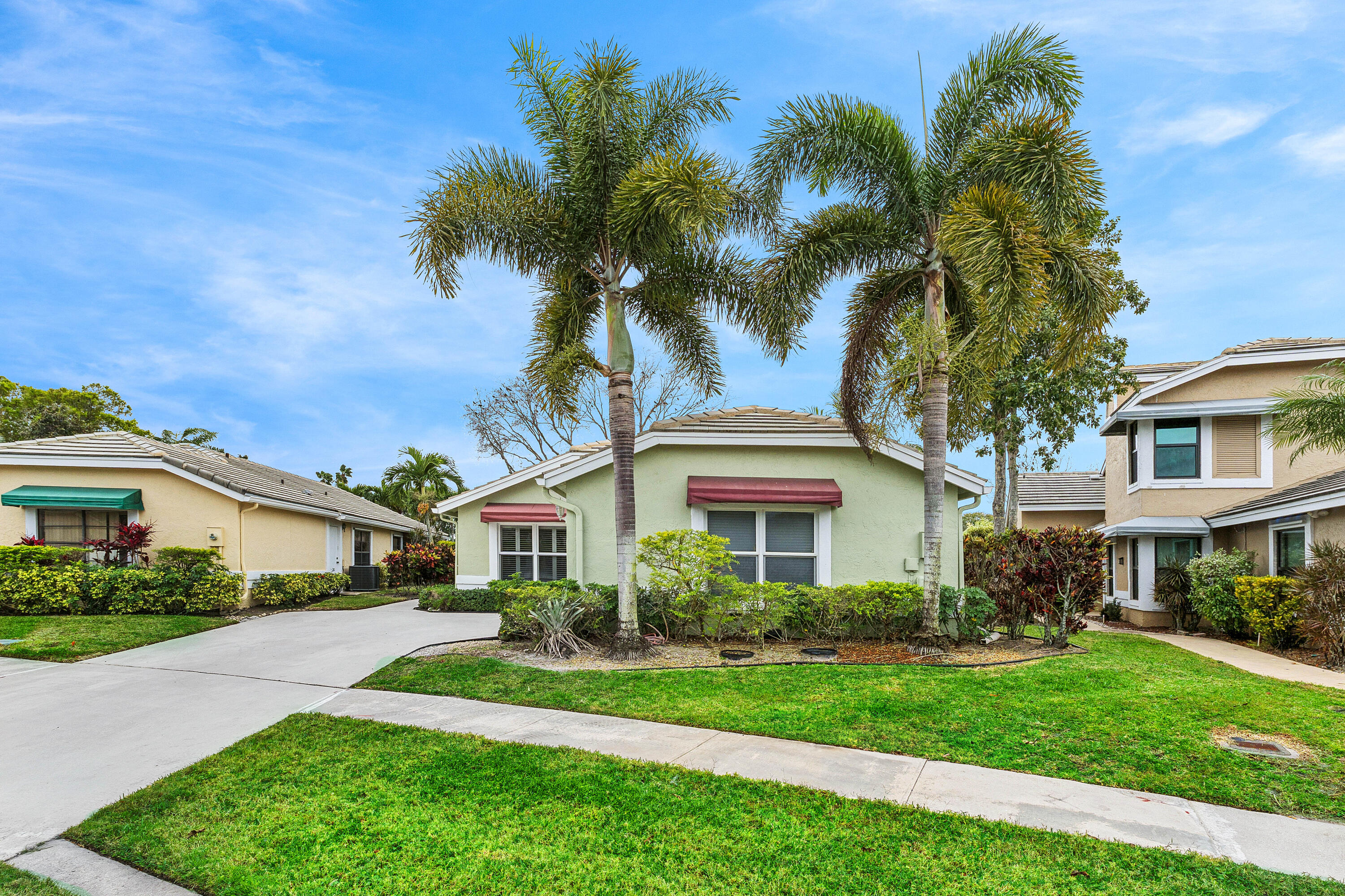 6249 Beaconwood Road Lake Worth, FL 33467 - Photo 3 of 46 a front view of a house with a garden and tree