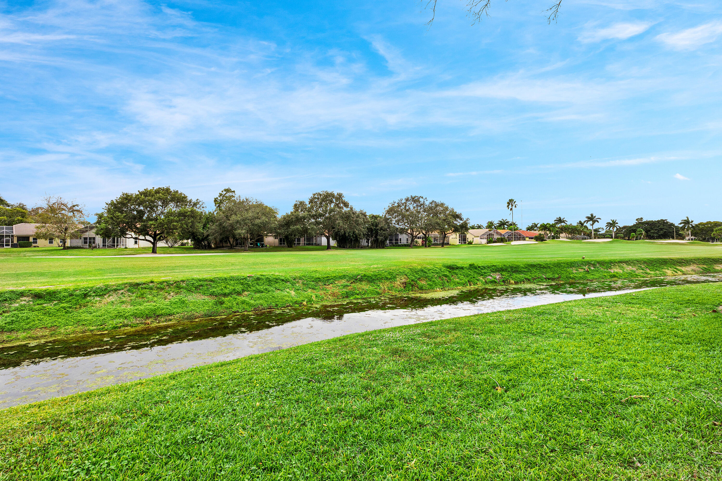 6249 Beaconwood Road Lake Worth, FL 33467 - Photo 31 of 46 a view of a golf course with a garden