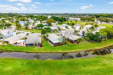 an aerial view of residential houses with outdoor space and swimming pool
