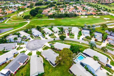 an aerial view of a residential houses with outdoor space and street view