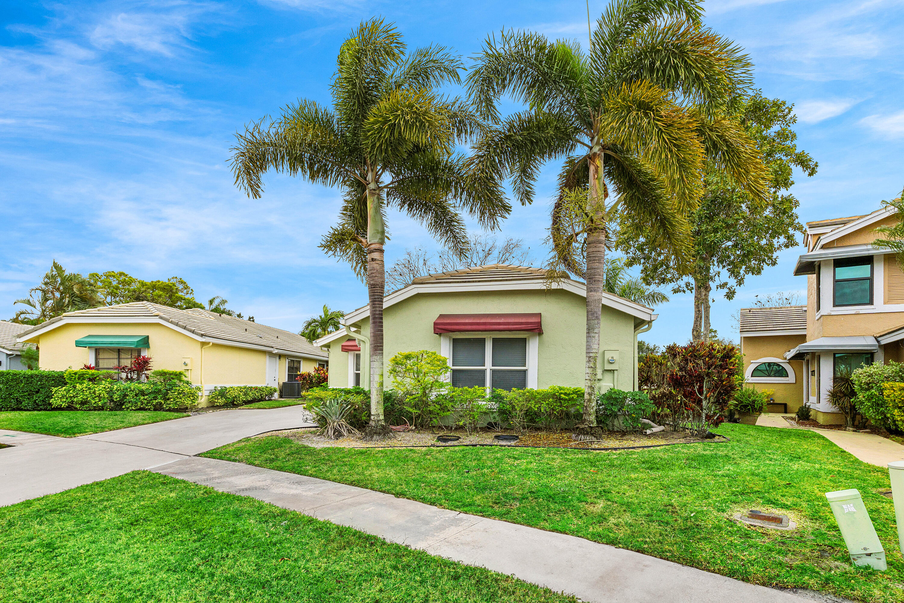 6249 Beaconwood Road Lake Worth, FL 33467 - Photo 4 of 46 a front view of a house with a garden