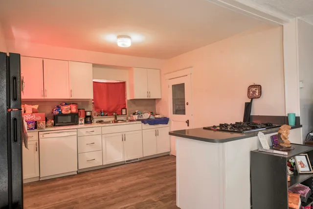 a kitchen with stainless steel appliances a sink stove and cabinets