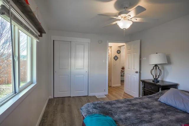a spacious bedroom with a large bed and a chandelier