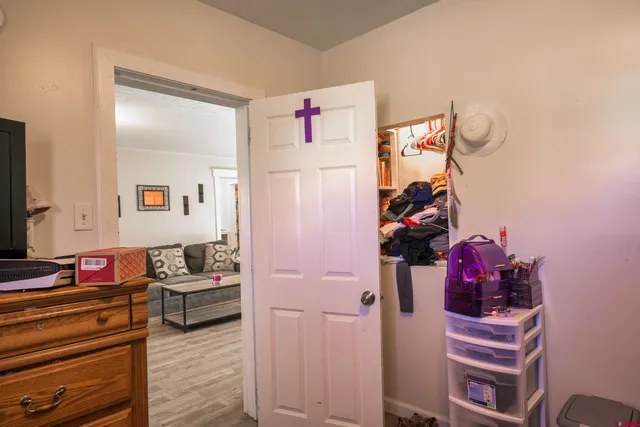 a view of walk in closet with clothes and shoes