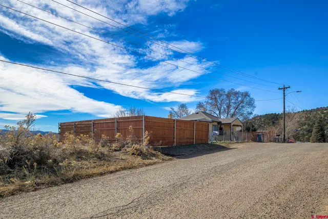 an aerial view of residential houses with large trees