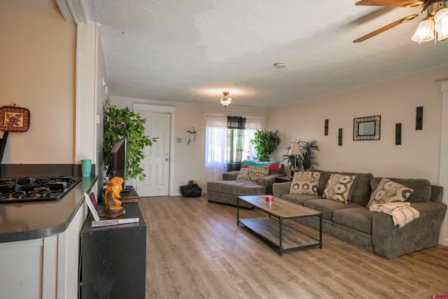 a living room with furniture and a wooden floor
