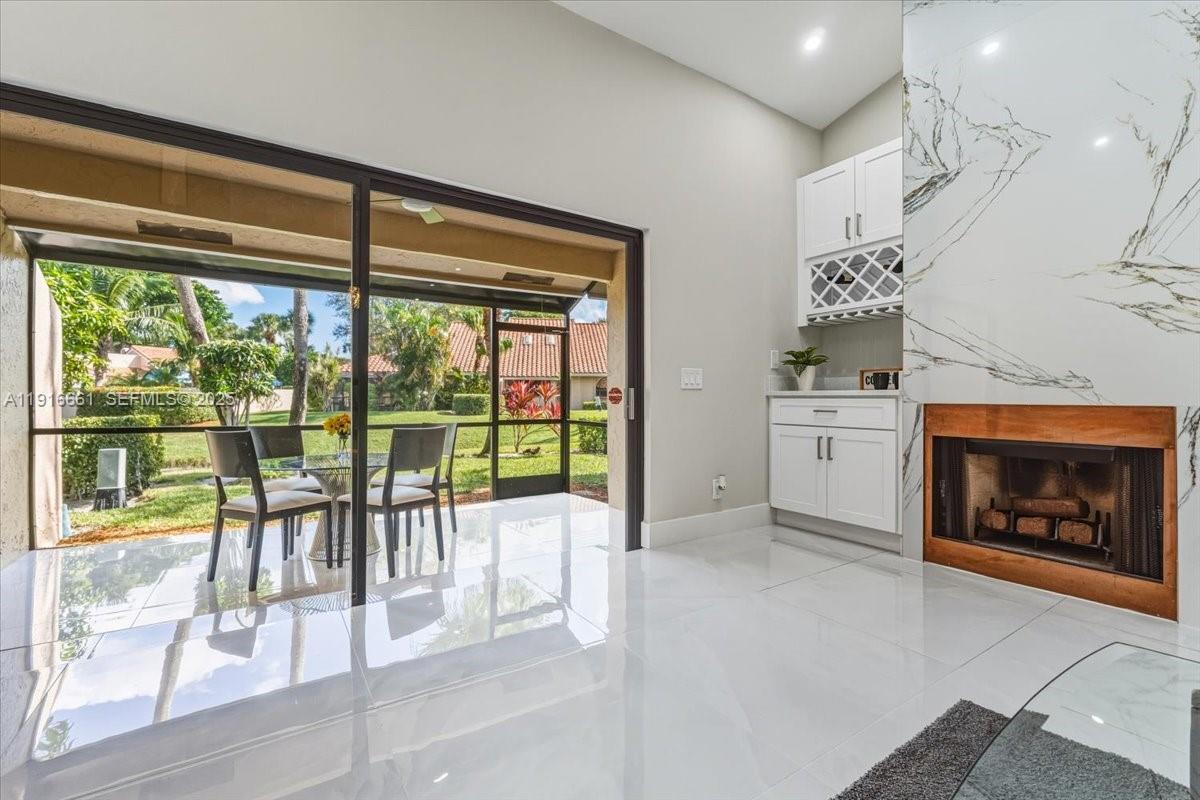 22708 Meridiana Drive Boca Raton, FL 33433 - Photo 11 of 46 a floor to ceiling window and a fireplace