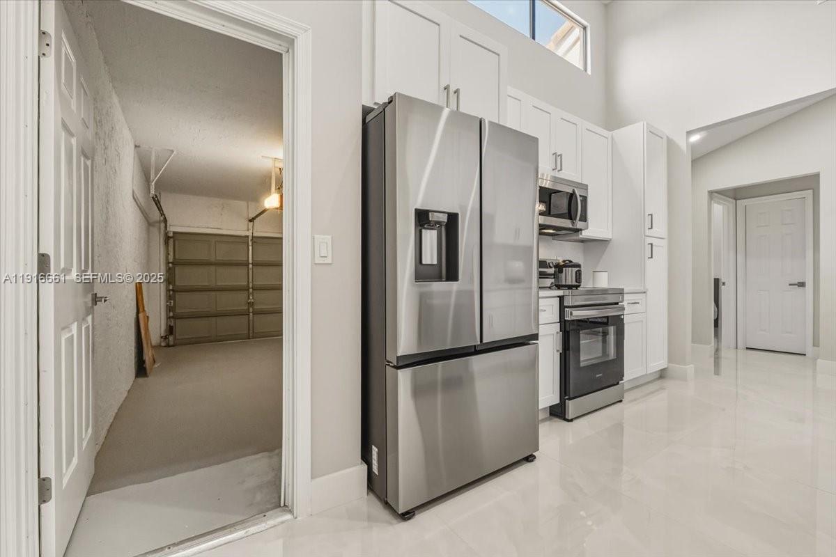 22708 Meridiana Drive Boca Raton, FL 33433 - Photo 18 of 46 a view of a kitchen with refrigerator and stove