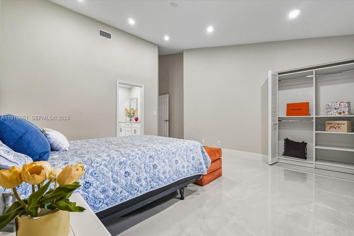 22708 Meridiana Drive Boca Raton, FL 33433 - Photo 24 of 46 a bedroom with bed and window