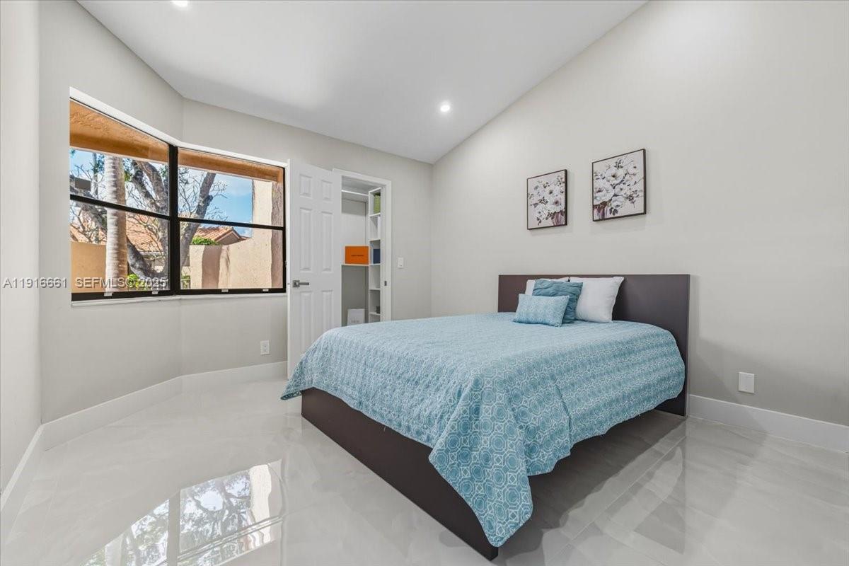 22708 Meridiana Drive Boca Raton, FL 33433 - Photo 30 of 46 a bedroom with a large bed and a window