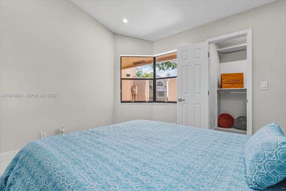 22708 Meridiana Drive Boca Raton, FL 33433 - Photo 31 of 46 a bedroom with a bed and a window