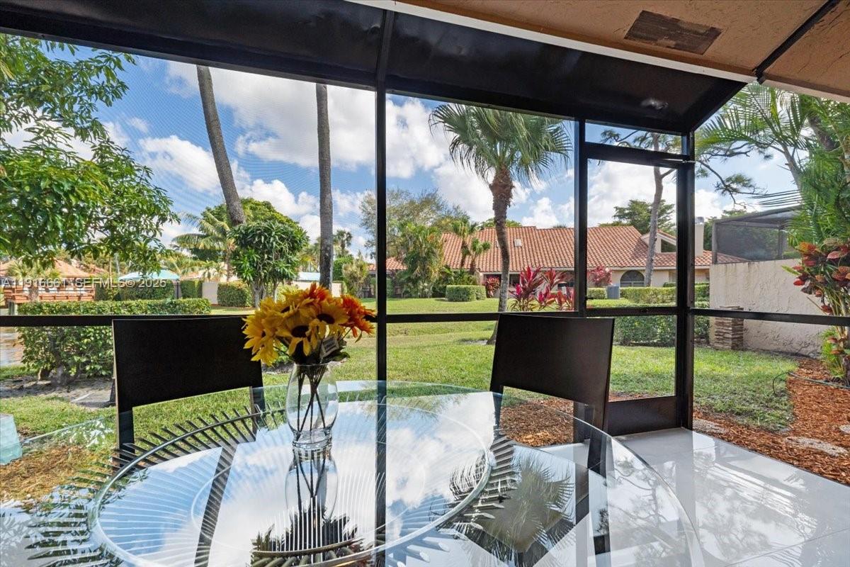 22708 Meridiana Drive Boca Raton, FL 33433 - Photo 37 of 46 a view of a porch with furniture and a yard