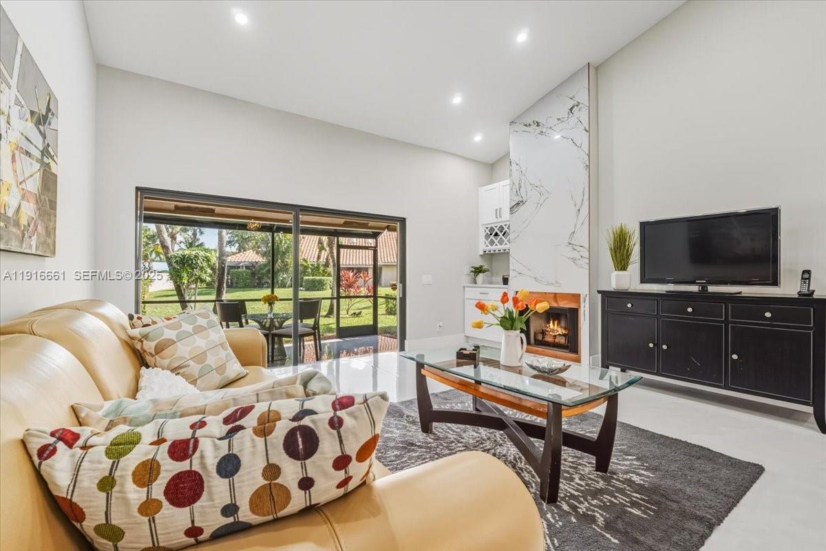 22708 Meridiana Drive Boca Raton, FL 33433 - Photo 8 of 46 a living room with furniture and a flat screen tv