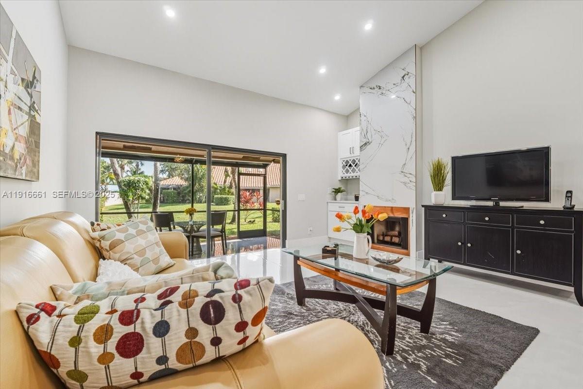 22708 Meridiana Drive Boca Raton, FL 33433 - Photo 9 of 46 a living room with furniture and a flat screen tv