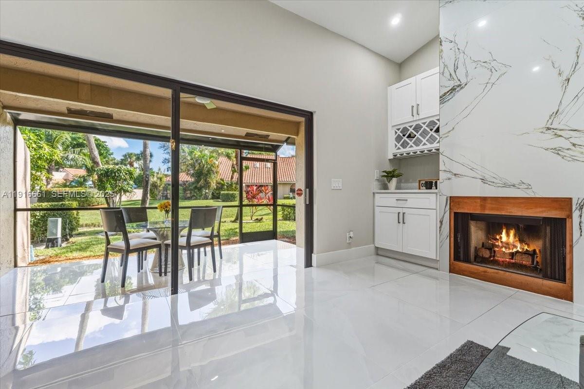 22708 Meridiana Drive Boca Raton, FL 33433 - Photo 10 of 46 a living room with furniture and a fireplace