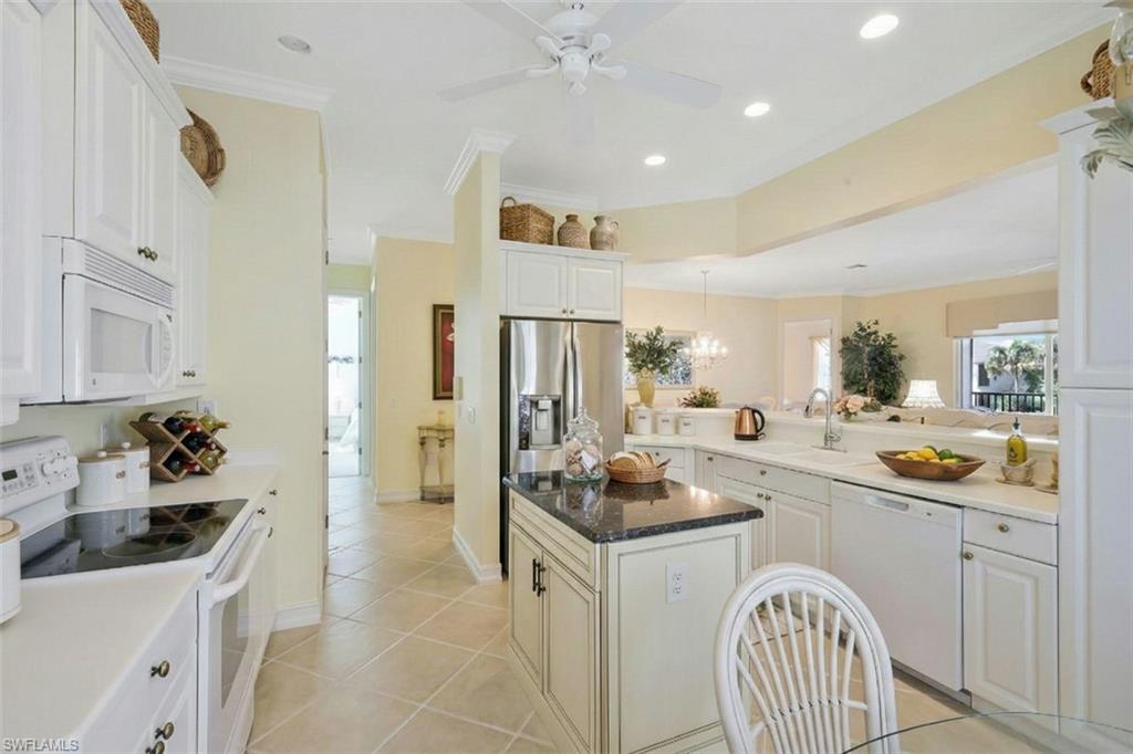 5025 Blauvelt Way, Unit 202 Naples, FL 34105 - Photo 12 of 26 a kitchen with a sink stove and refrigerator