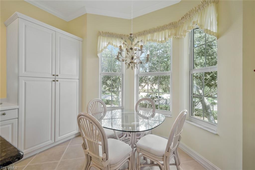 5025 Blauvelt Way, Unit 202 Naples, FL 34105 - Photo 13 of 26 a dining room with furniture and window