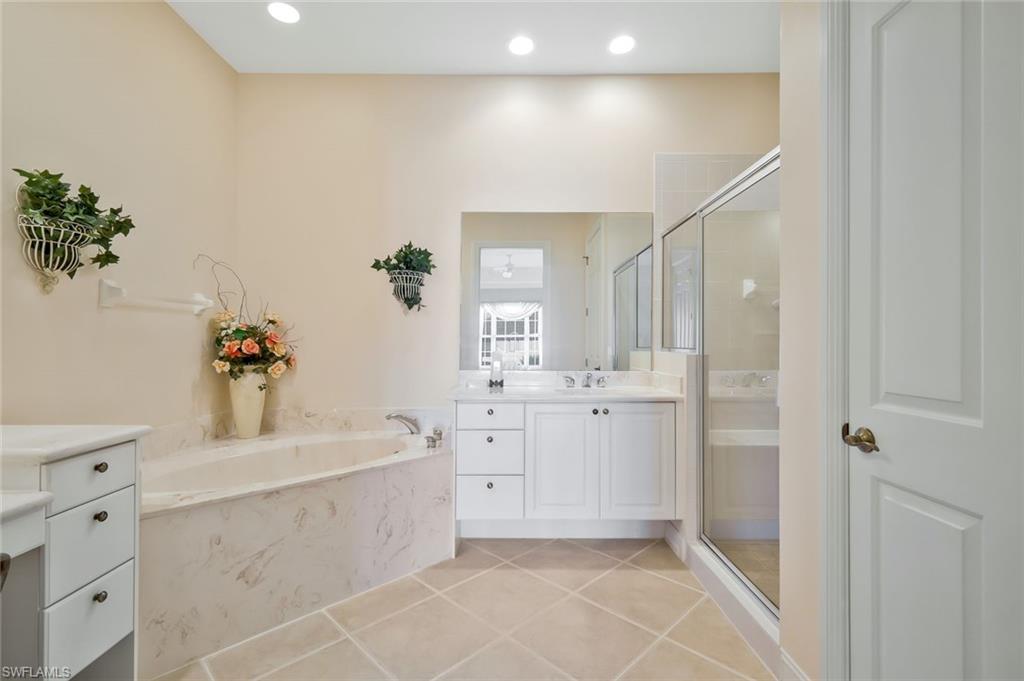 5025 Blauvelt Way, Unit 202 Naples, FL 34105 - Photo 14 of 26 a bathroom with a sink a vanity and a mirror