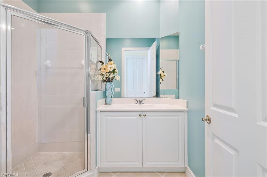 5025 Blauvelt Way, Unit 202 Naples, FL 34105 - Photo 15 of 26 a bathroom with a sink and mirror